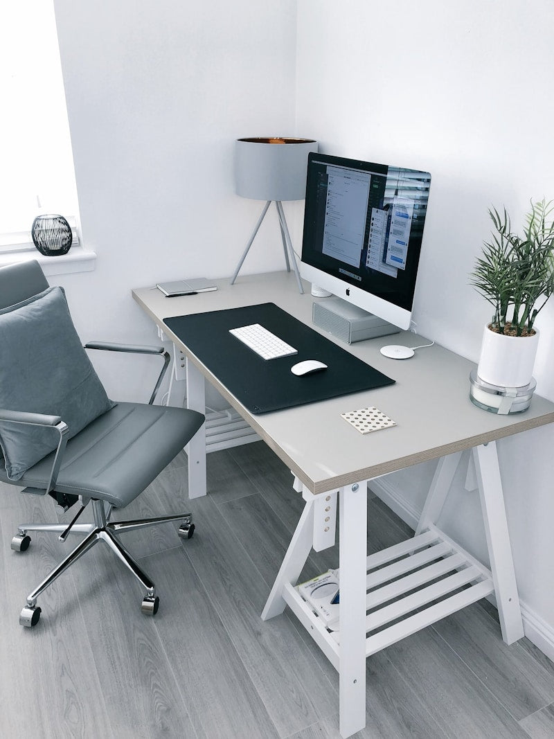 Modern electric standing desk in bright home office setup